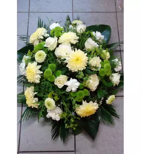 Round-shaped funeral arrangements in creamy, white and green tones