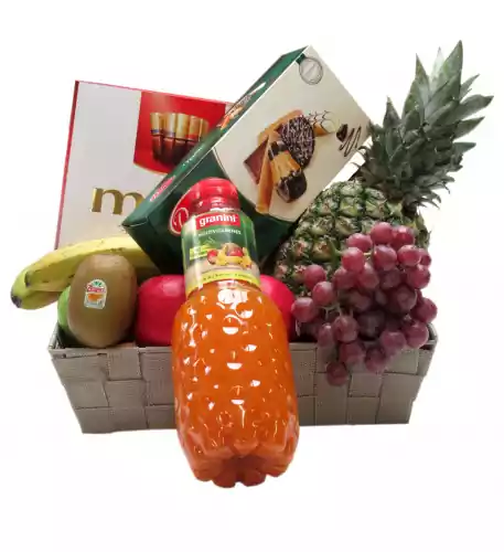 Fruit basket with fruit juice cookies and chocolate
